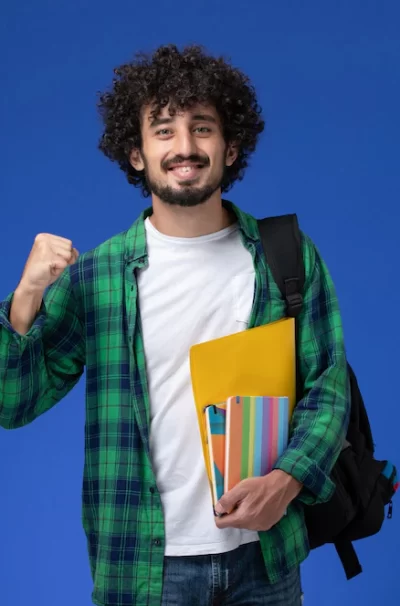 front-view-male-student-wearing-black-backpack-holding-copybooks-files-blue-wall_140725-42636